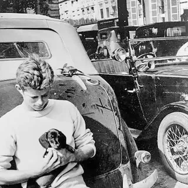 John F. Kennedy with his Dachshund Dunker during his summer tour trough Europe in 1937. The Hague, The Netherlands.