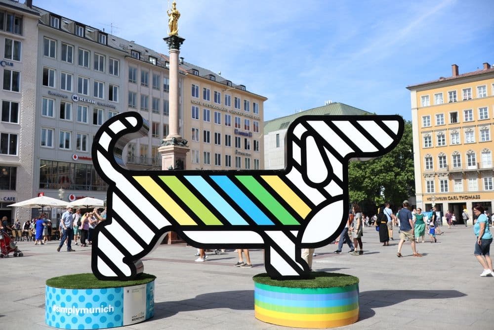 Dachshund in Art – colourful modern Dachshund sculpture with striped design displayed in Munich city square on sunny day – Dachshund Lovers